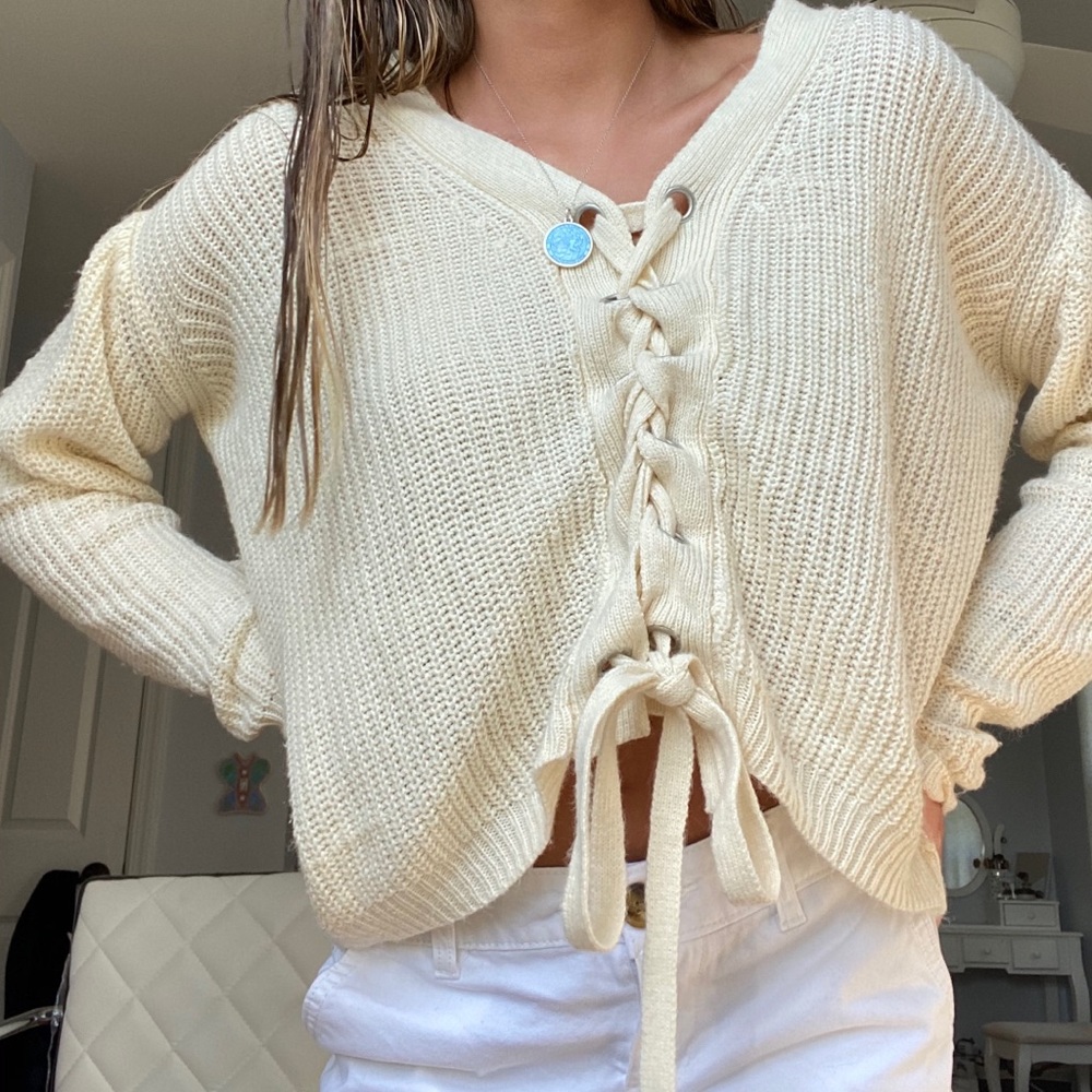 Super cute creme sweater with ties in front!